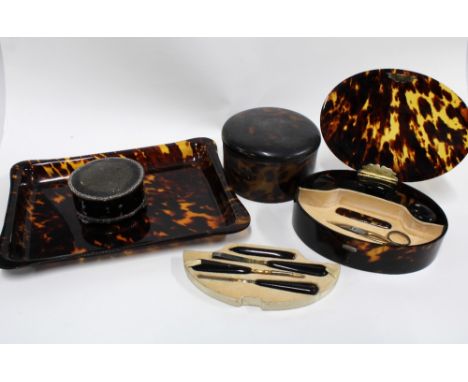 An Edwardian silver mounted tortoiseshell box and a tortoiseshell manicure set in an oval box with a silver hinge, tortoisesh