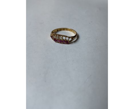 An 18ct gold ruby and diamond ring. Two vacant diamonds. 1.8g size M