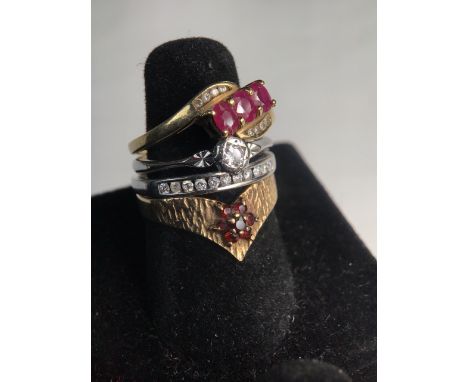 Four 9ct gold rings to include a single stone diamond ring, half set diamond eternity ring and two ruby set rings. 8.4g