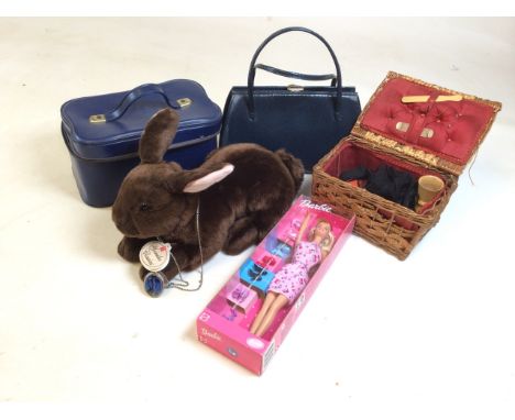 An assortment of items including a 2001 Mattel Barbie, soft toy rabbit, blue handbag and dress jewellery.