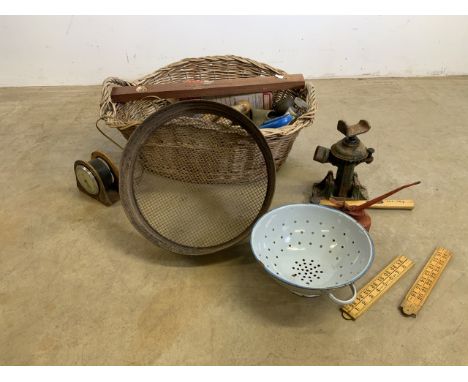 A wicker basket to include tools and metalware.