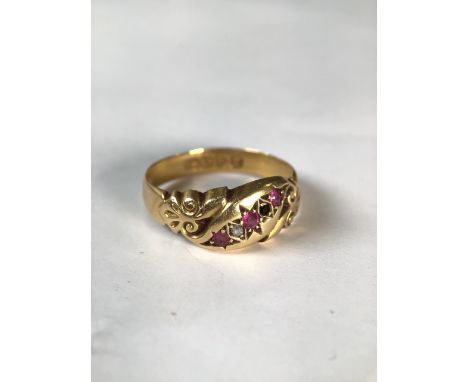 An 18ct gold ruby and diamond ring. Three small single cut rubies with two single cut diamonds(one vacant) 2.2g size N.