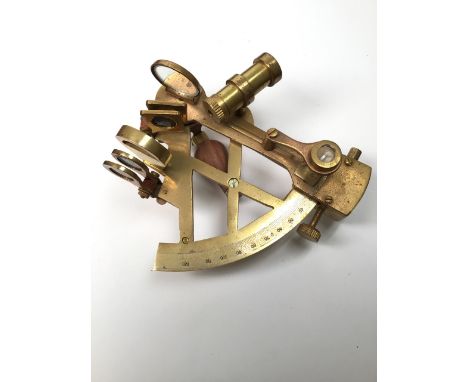 A brass sextant in wooden box