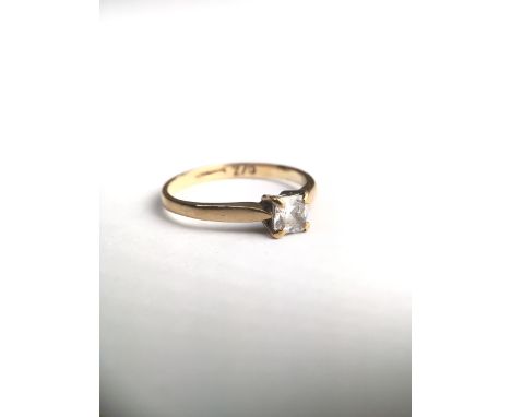 An 18ct gold and CZ ring. Central square cut stone in a four claw setting. 1.5g Size K.