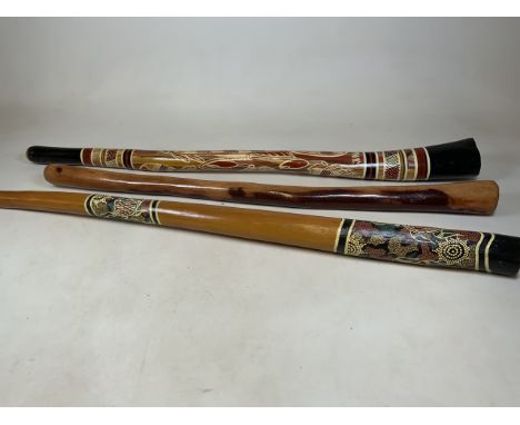 A didgeridoo by Rodney Jungal King along with two unmarked didgeridoos. Longest 140cm.