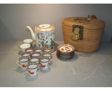 Early C20th Chinese teaset, lidded teapot &amp; pair of cups in fitted raffia case, 4 character marks in red to base of teapo