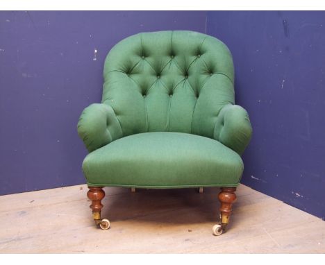 Victorian green upholstered button back arm chair, in turned legs to castors (1 leg needs re-attaching) 