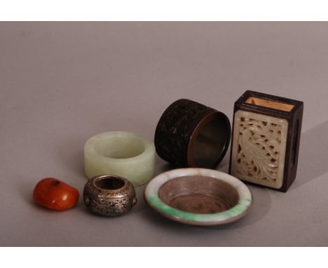 A group of Chinese mixed lot to include a carved coconut shell napkin ring, a jade napkin ring, a jade-mounted rectangular ma