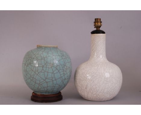 C19th Chinese pale green crackle-glazed jar, 21.5cm high, wood stand; together with a white crackle-glazed bottle vase, mount