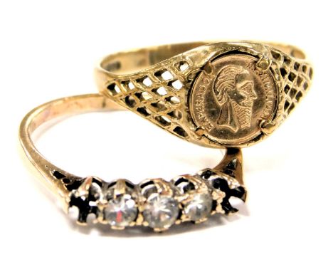 A 9ct gold and coin set signet ring, size Q, together with a 9ct gold and five stone ring, possibly white sapphires, two lack