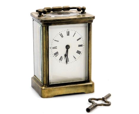 A brass cased carriage clock, rectangular enamel dial bearing Roman numerals, single barrel movement, the case of conventiona