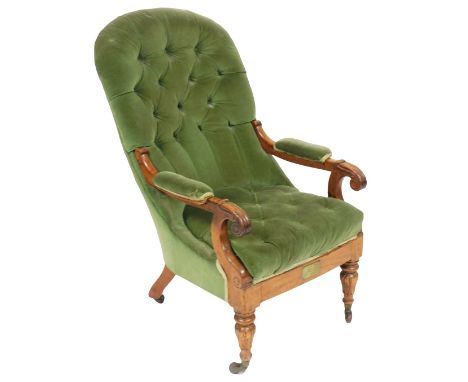 A Victorian mahogany spoon back armchair, upholstered in button back green draylon, raised on turned legs, brass capped on ca