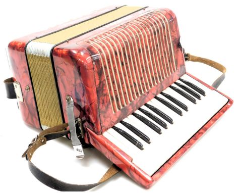 A Hohner Student II accordion, with red cracked ice casing twelve button, cased.