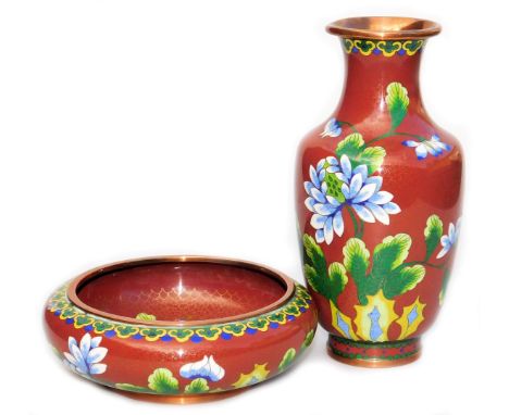 A Chinese iron red ground cloisonne enamel vase, of baluster form, decorated with blue flowers within a ground of gilt stars,