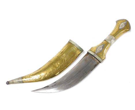 A Yemeni Jmbiya dagger, brass and silver, with an engraved steel blade, with scabbard, 30cm long.