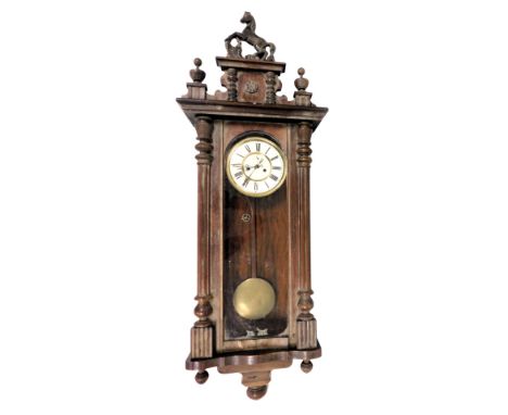 A late 19thC mahogany cased Vienna wall clock, circular brass dial with enamel chapter ring bearing Roman numerals, subsidiar