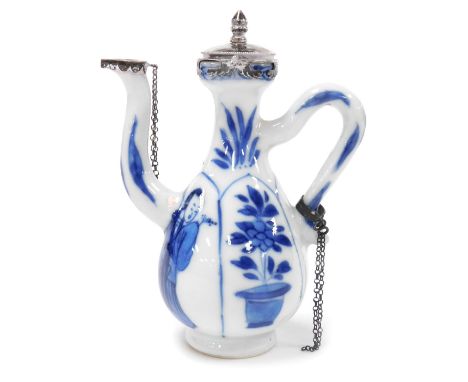 A Kangxi blue and white porcelain export ewer. of fluted, pear form, decorated with panels of ladies, and pots of flowers, wi