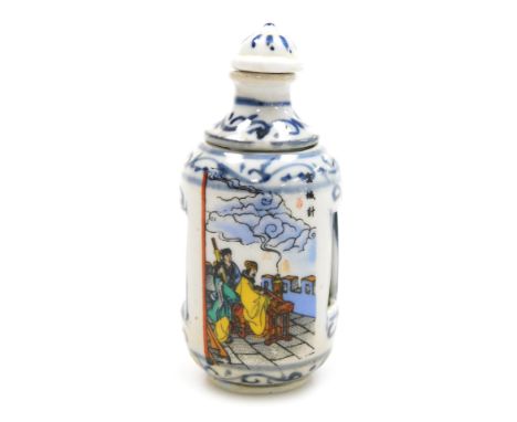 A 20thC Chinese porcelain erotic snuff bottle, of cylindrical form, with a revolving top and inner section decorated with a c