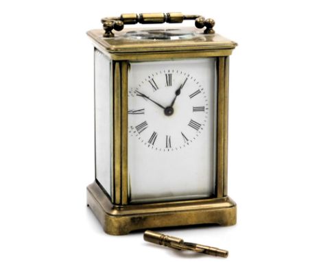 A brass cased carriage clock, rectangular enamel dial bearing Roman numerals, single barrel movement, the case of conventiona