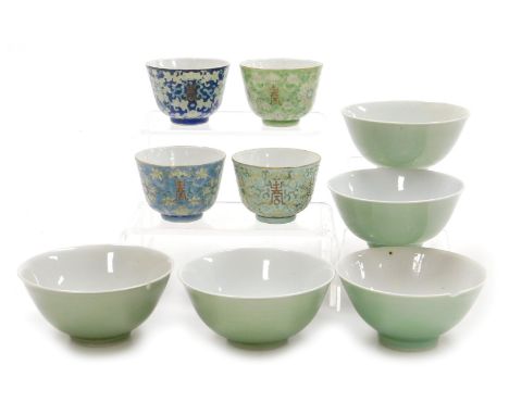 Four 20thC Chinese porcelain wine cups, decorated with lotus flowers and calligraphy, on vari-coloured enamel grounds, red si