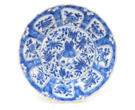 A Kangxi porcelain blue and white kraak plate, decorated with flowers, within a prunus blossom and cracked ice ground, arteme
