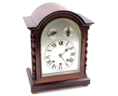 An Edwardian mahogany cased mantel clock, domed silvered dial, with chapter ring bearing Roman numerals, subsidiary chime, si