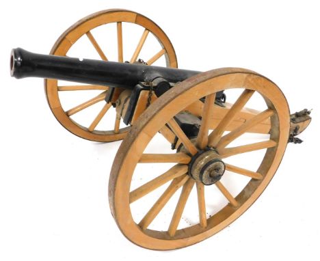 A wooden and cast iron scale model of a Napoleonic era canon, 70cm wide. 