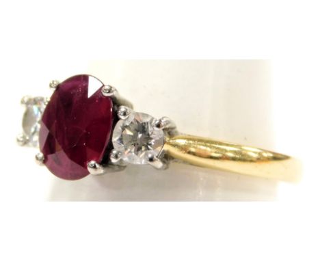 An 18ct gold ruby and diamond three stone ring, ruby approximately 0.75 carat, diamonds approximately 0.5 carat, size 0/P, 4.