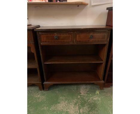 A dwarf bookcase with two drawers and shelf under 