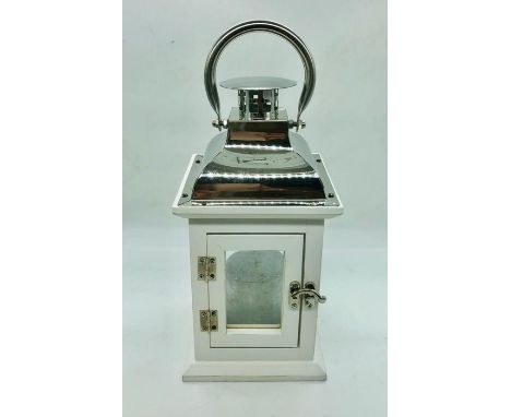 A small white painted wood and chrome lantern with silver candle 