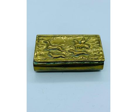 A brass snuff box depicting a hunting scene 