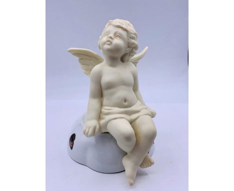 A Cherub, posed to sit on a ledge or shelf 