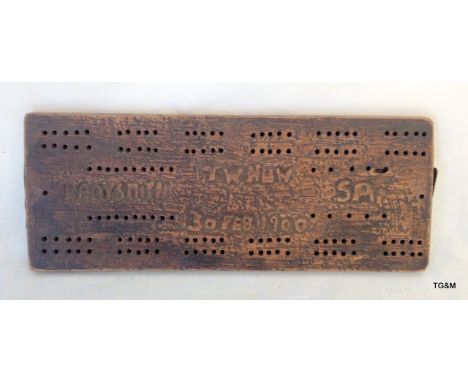 A Boer War wood cribbage board with TW HUW LADYSMITH SA 30 FEB 1900 carved into it 28 x 11 cms