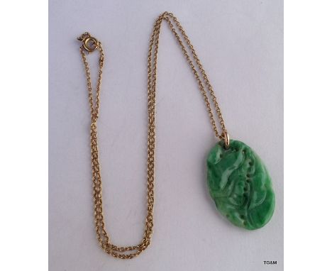 A carved Jade necklace on a 9ct gold chain and mount