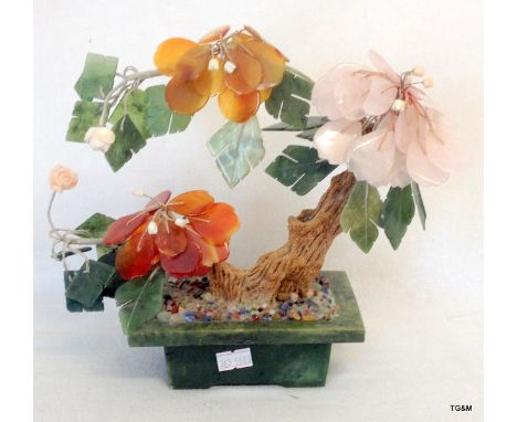 A Chinese Jade pot containing a tree decoration with Jade, Coral, Agate and Rose quartz flower, heads and leaves