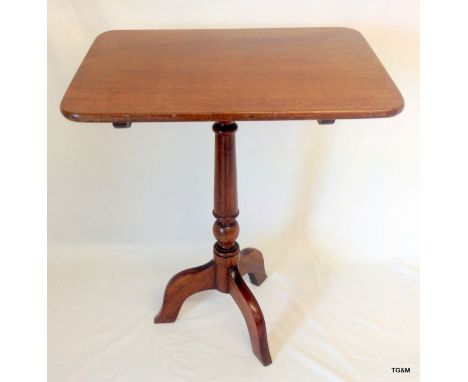 A Victorian mahogany tilt top occasional table standing on tripod supports