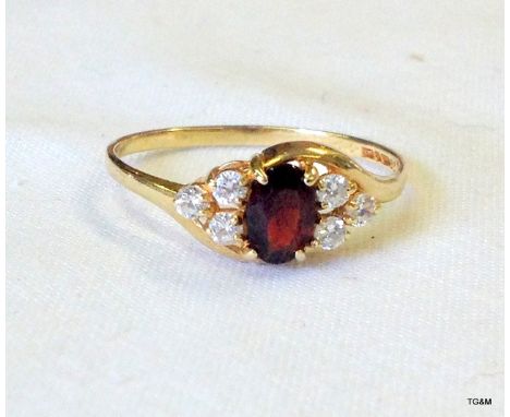 A 9ct gold garnet ring size R