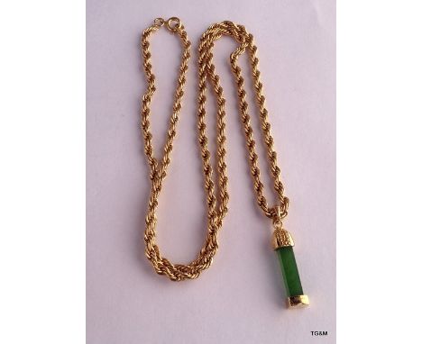 A jade pendant with Yellow metal setting an a yellow metal chain