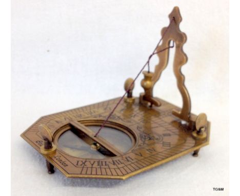 A brass cased sundial and compass