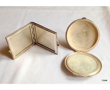 A silver picture frame with a silver compact