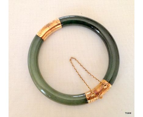 A Jade & Gold Mounted Bangle