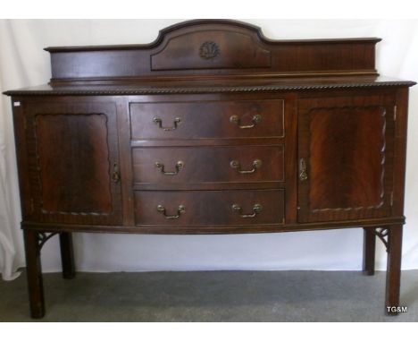 A mahogany bow fronted three draw sideboard with pie crust and galleried top 