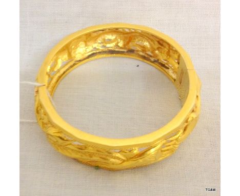 A Chinese gold bangle with dragon decoration, 40 grams