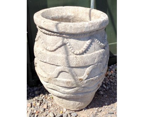 A very large cast concrete garden urn