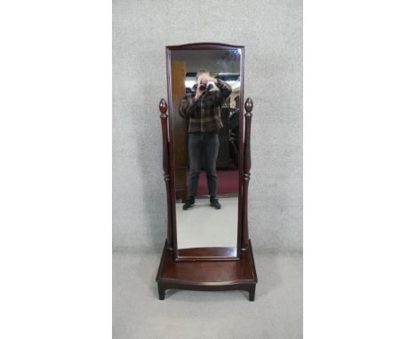 A contemporary cheval mirror with adjustable swing plate on platform base. H.153 W.63 D.44 CM 