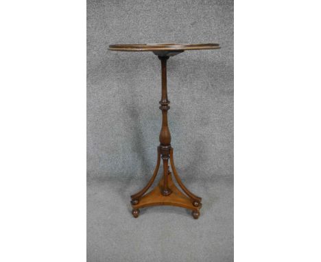 A 19th century mahogany and satinwood strung Empire style lamp table table with central inlaid fan patera on tripod platform 