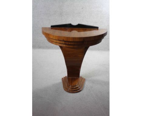 An Art Deco style figured walnut and ebonised demi lune console table with shaped support on stepped base. H.85 W.98 D.47 cm 