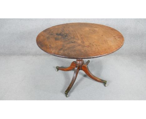 An early 19th century mahogany tilt top table on ring turned column and quadruped swept supports. H.73 x D.112cm 