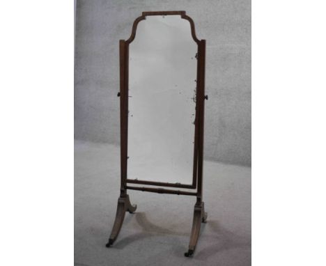A C.1900 mahogany framed cheval mirror with original plate on swept reeded supports. H.149 W.56 D.60 cm. 