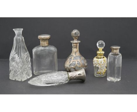 A collection of dressing table bottles and perfume bottles. Including a pierced silver and glass bottle with stopper, two gla